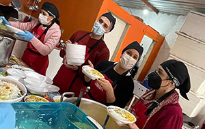 Tate & Lyle colleagues serving meals in a kitchen