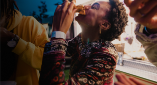 A woman eating a meal with friends