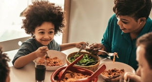 Small child enjoying family meal