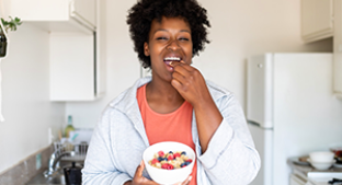 Smiling woman eating a fortified breakfast cereal