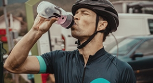 Cyclist drinking a sports nutrition beverage